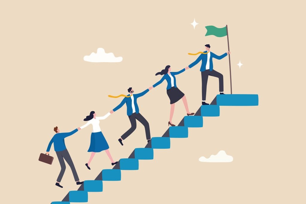 Illustration of five business people climbing blue stairs, holding hands. The leader at the top holds a green flag, symbolizing teamwork and guiding others to success. Clouds float in the background.
